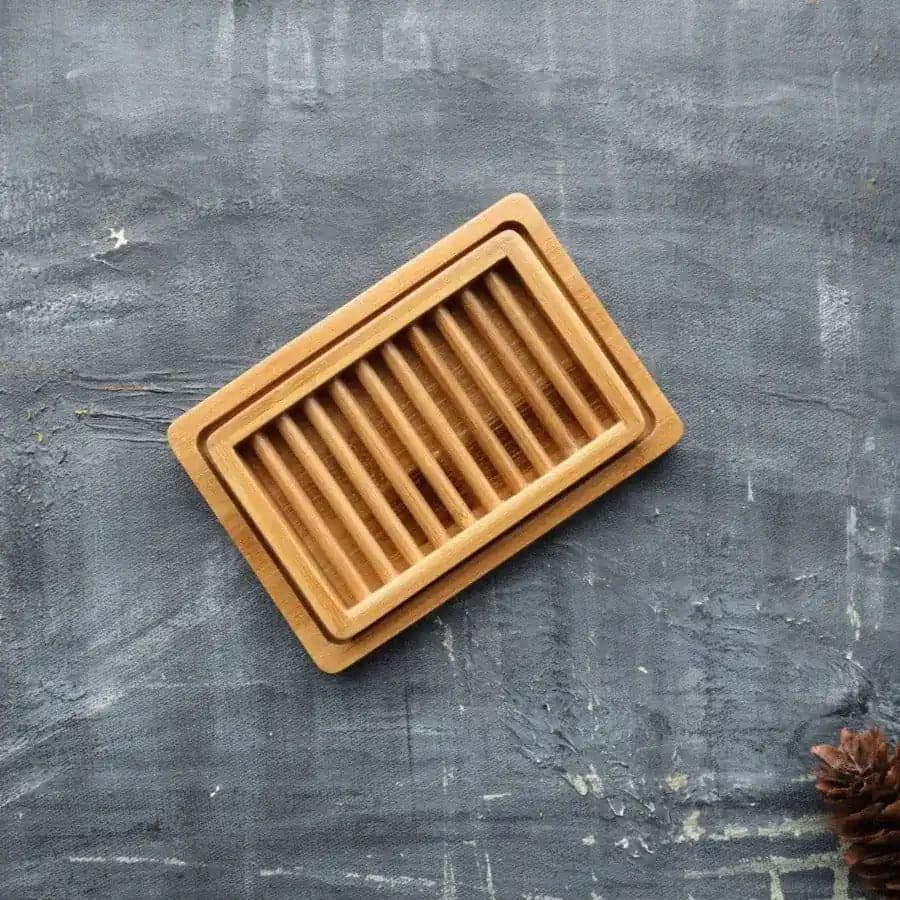 Dual-layer bamboo soap dish featuring slotted drying rack and draining tray in natural wood finish