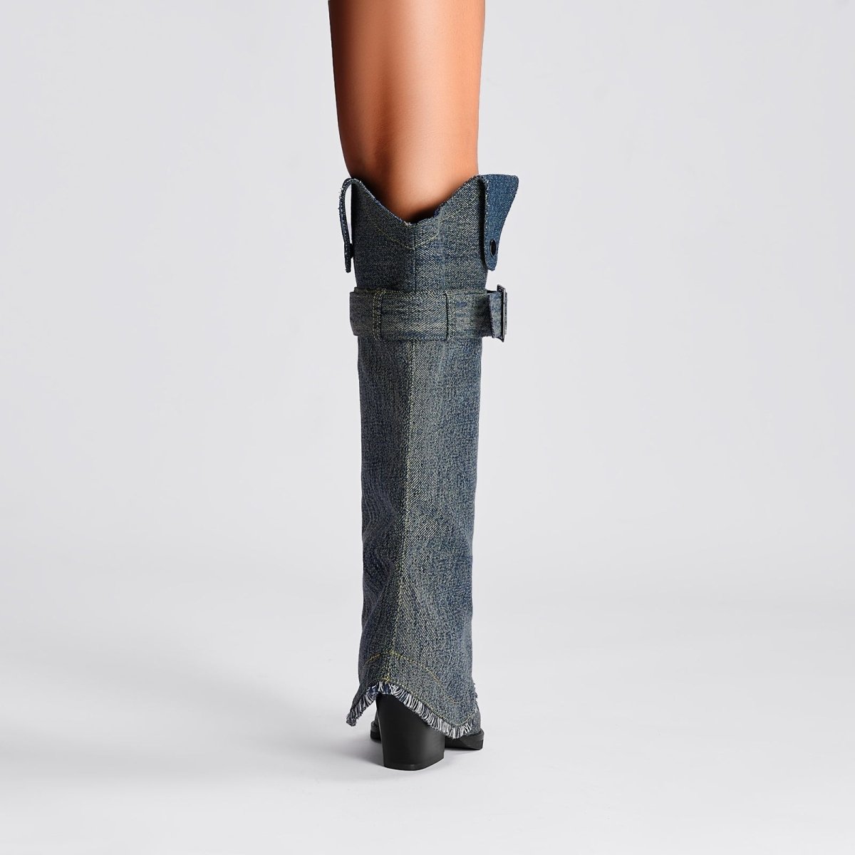 Denim buckle foldover knee high boots with pointed toe, slouchy shaft, and frayed hem detail. — view 2