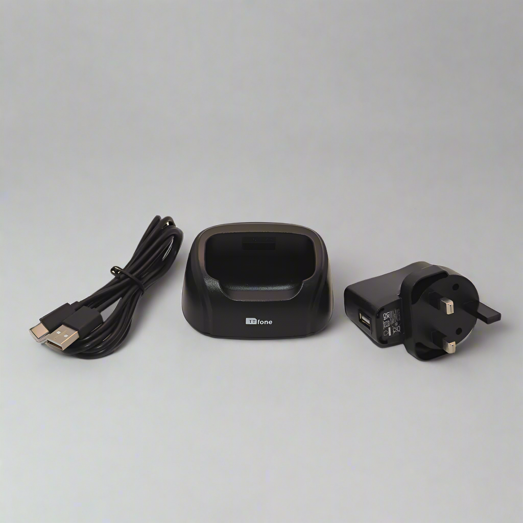 Black TTfone desktop charging dock stand holding a Nova TT650 mobile phone securely upright — view 3