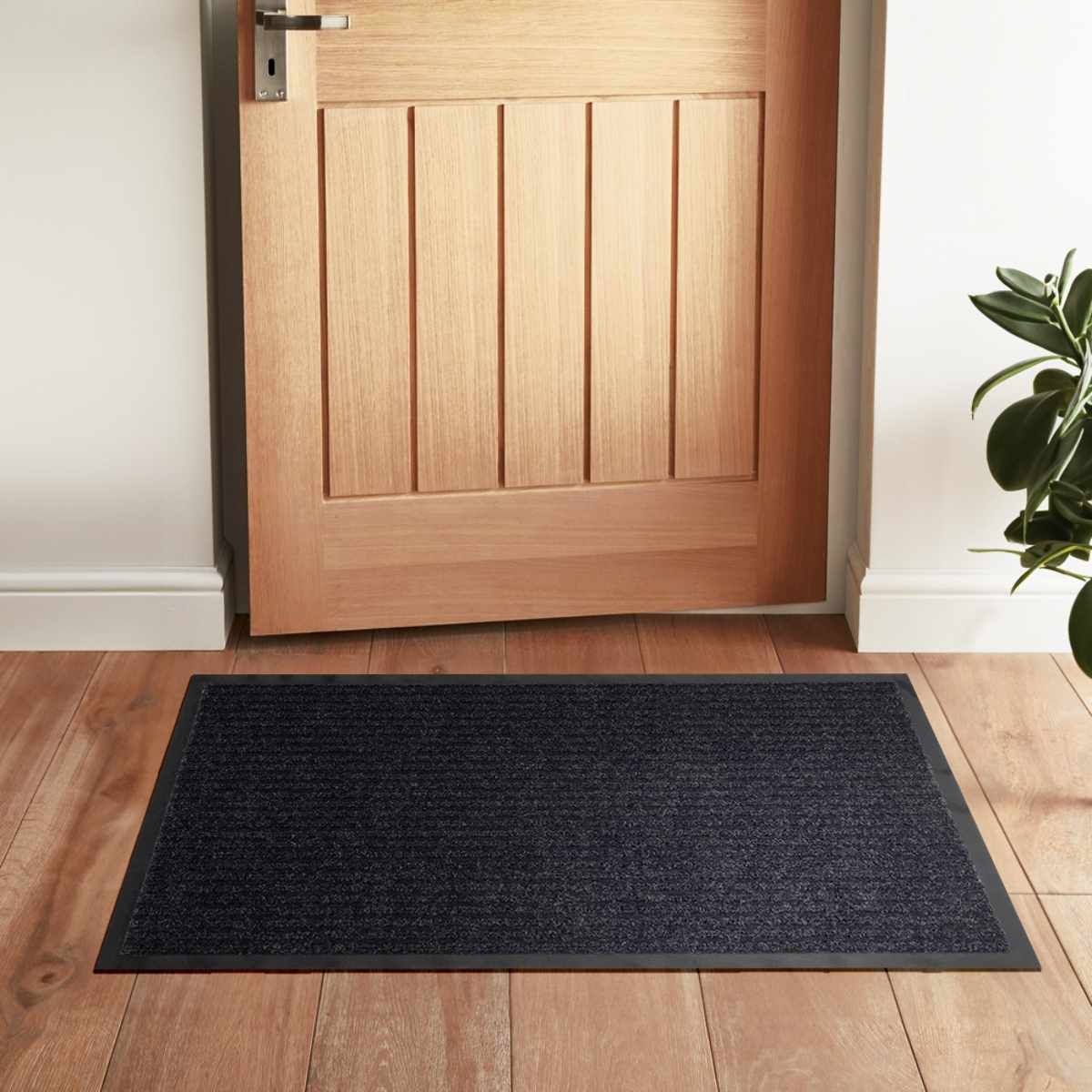 Basic black outdoor doormat, low profile polyester mat with rubber backing for porches and entryways — view 4