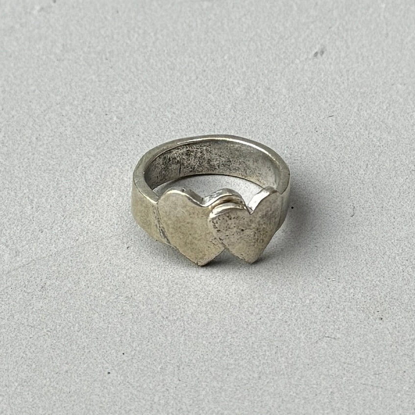 Crossed hearts silver ring with adjustable open back and distressed vintage style finish.