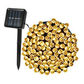 Multicolor solar string lights wrapped on copper wire with attached ground stake and solar panel