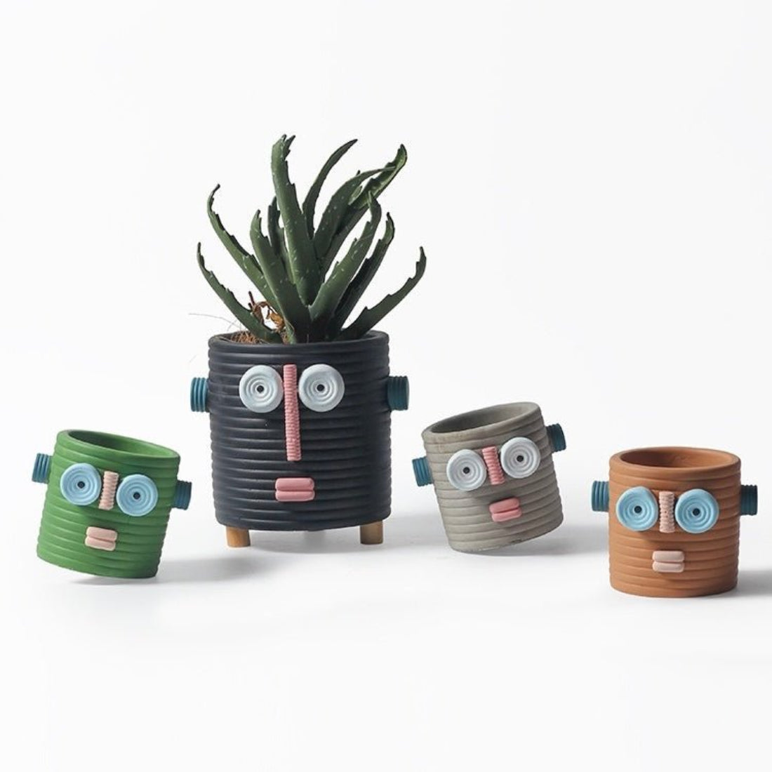 Handmade ceramic dummy robot flower pot displaying a green succulent plant on a garden patio. — view 4