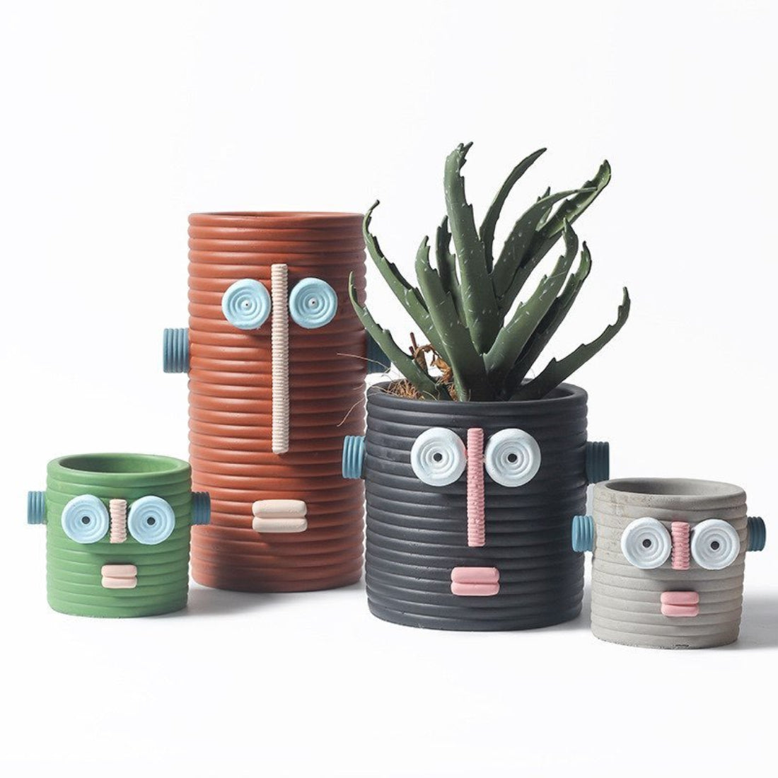 Handmade ceramic dummy robot flower pot displaying a green succulent plant on a garden patio. — view 3