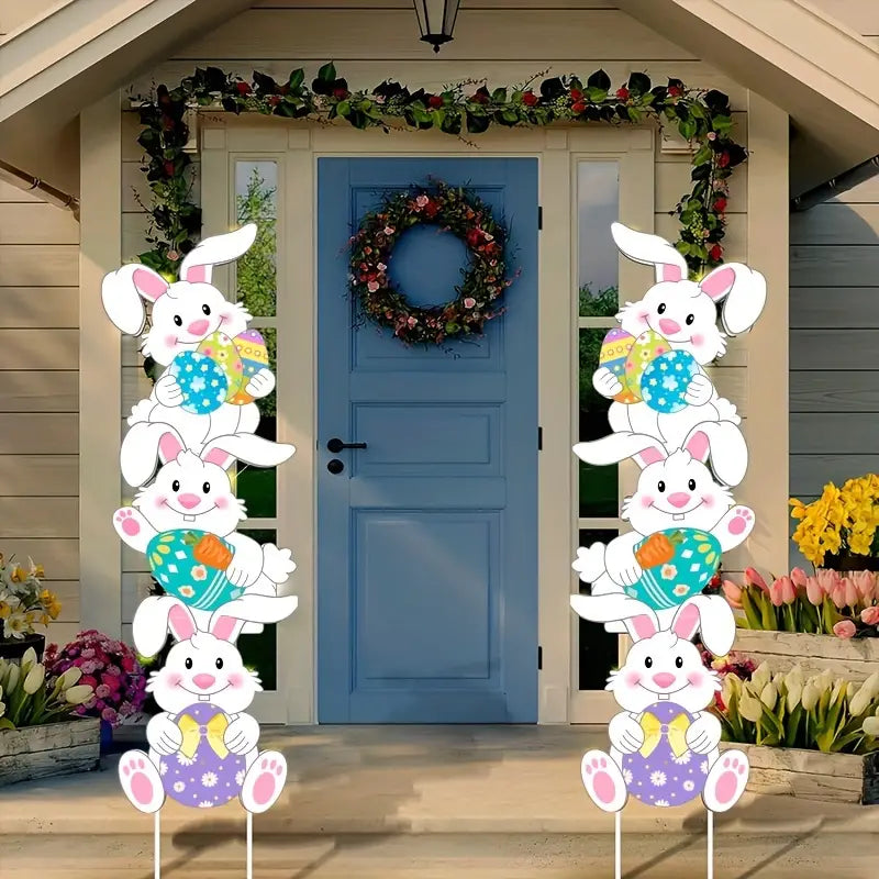 Tumbling bunnies yard stakes made of corrugated plastic displayed on a green grass lawn. — view 2