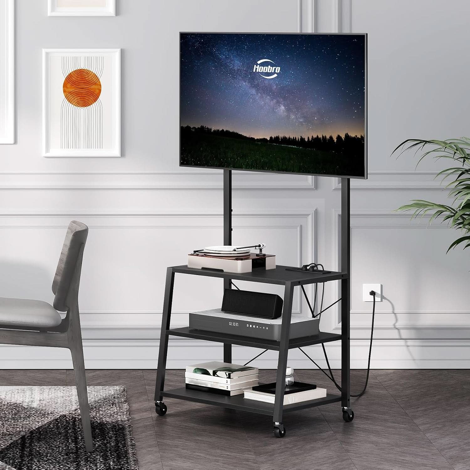 Black rolling TV stand with adjustable mounting rail, three storage shelves, and lockable caster wheels — view 5