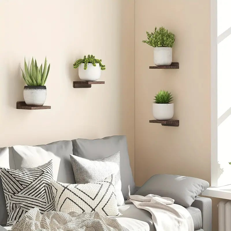 Four piece black wooden floating wall shelves displaying small potted plants and books — view 3