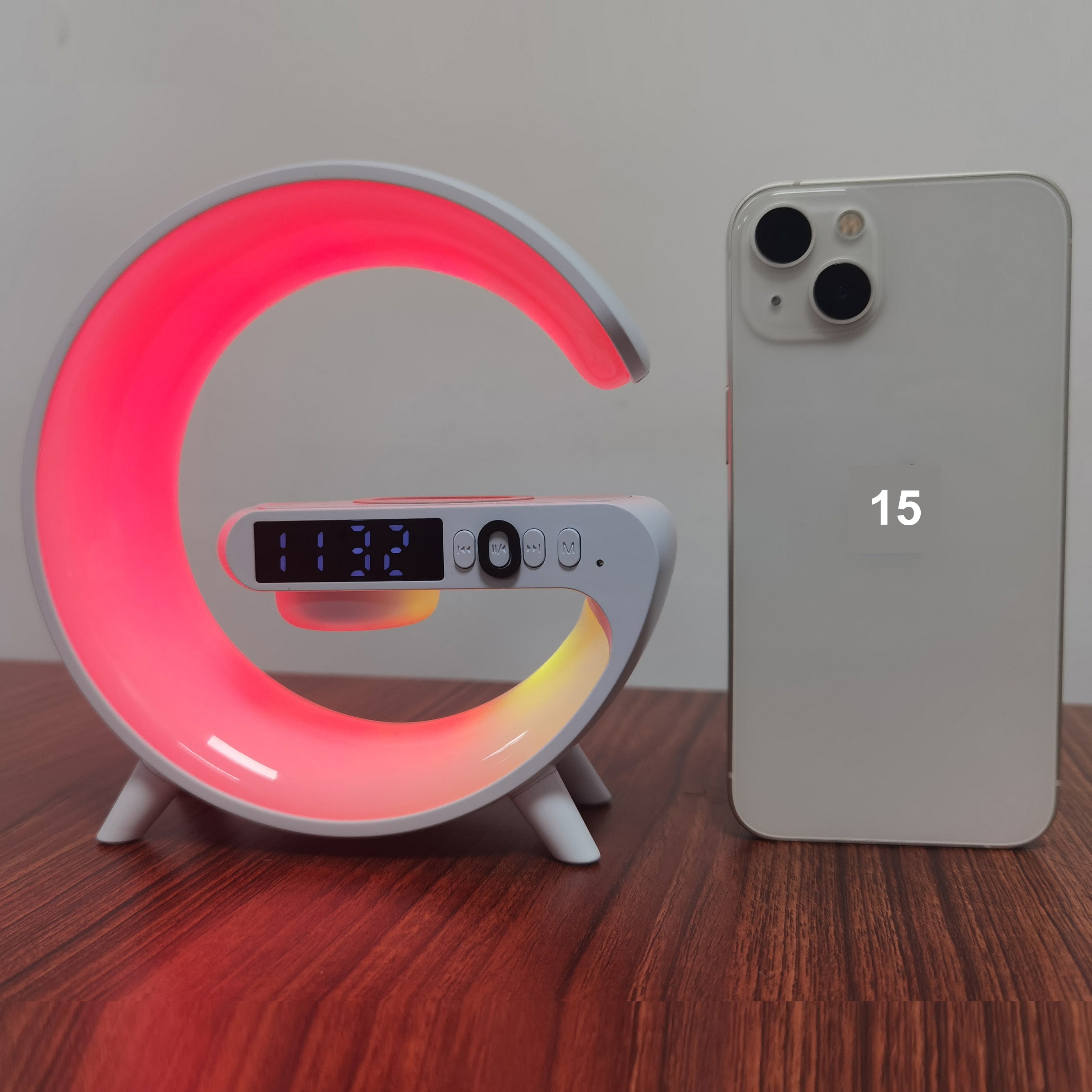 White wireless Bluetooth speaker with RGB rhythm light and fast charging base on a tabletop — view 4