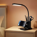Black LED desk lamp with wireless charger base, pen holder, and flexible gooseneck.