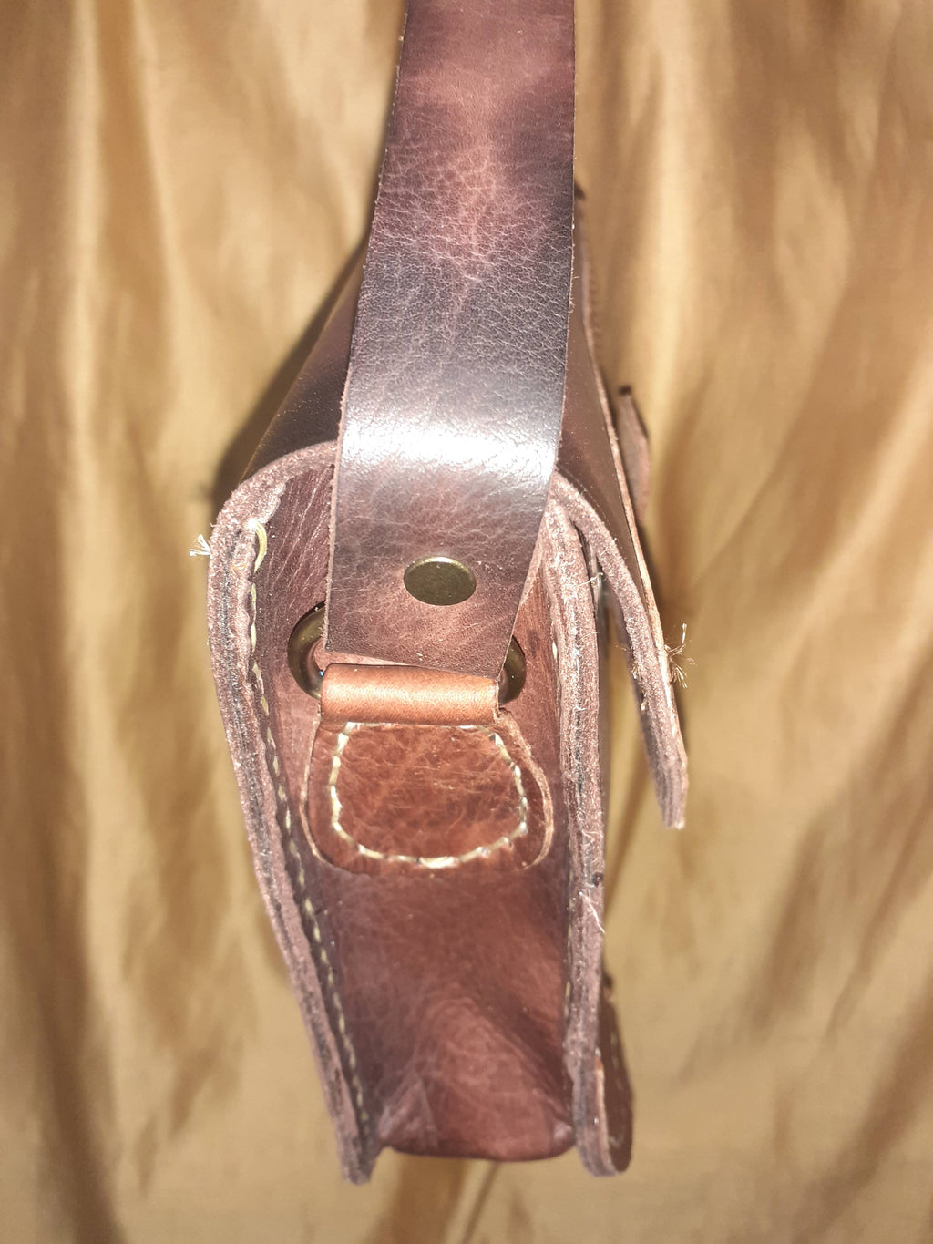 Two-tone leather crossbody bag with rustic finish, front zipper pocket, and long adjustable shoulder strap — view 10