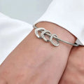 Personalized titanium steel love bracelet with an engraved peach heart charm in a metallic finish