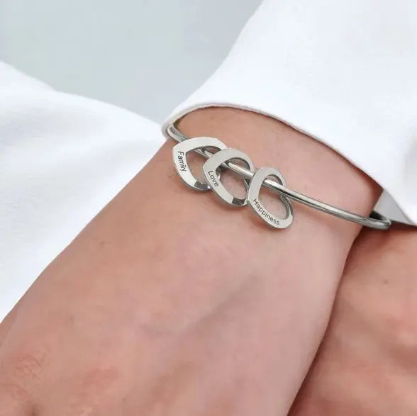 Personalized titanium steel love bracelet with an engraved peach heart charm in a metallic finish