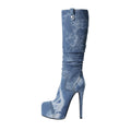 Elegant knee high washed denim stiletto boots with a pointed toe and rhinestone western paneling