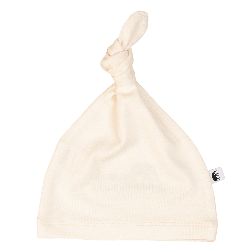 Cream bamboo baby beanie, soft and breathable hypoallergenic headwear for infants and toddlers.