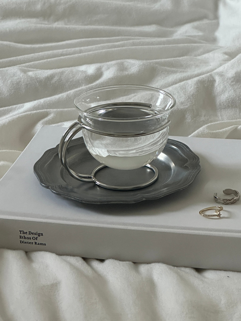 Clear vintage glass coffee cup resting in a sleek minimalist stainless steel wire holder — view 5