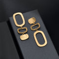 Square geometric dangle earrings featuring a minimalist metallic pendant design for daily office wear
