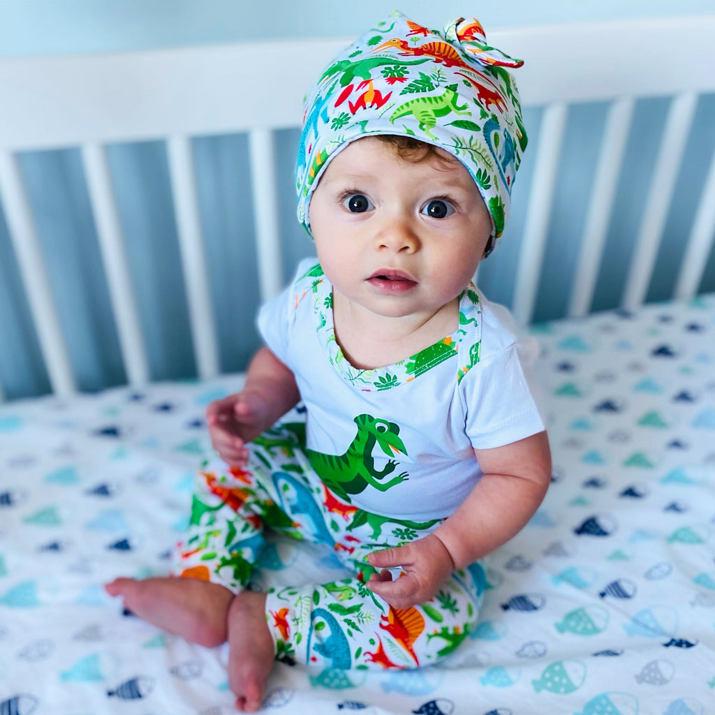 Baby boy 3-piece dinosaur layette set with bodysuit, green patterned joggers, and matching head cap — view 5