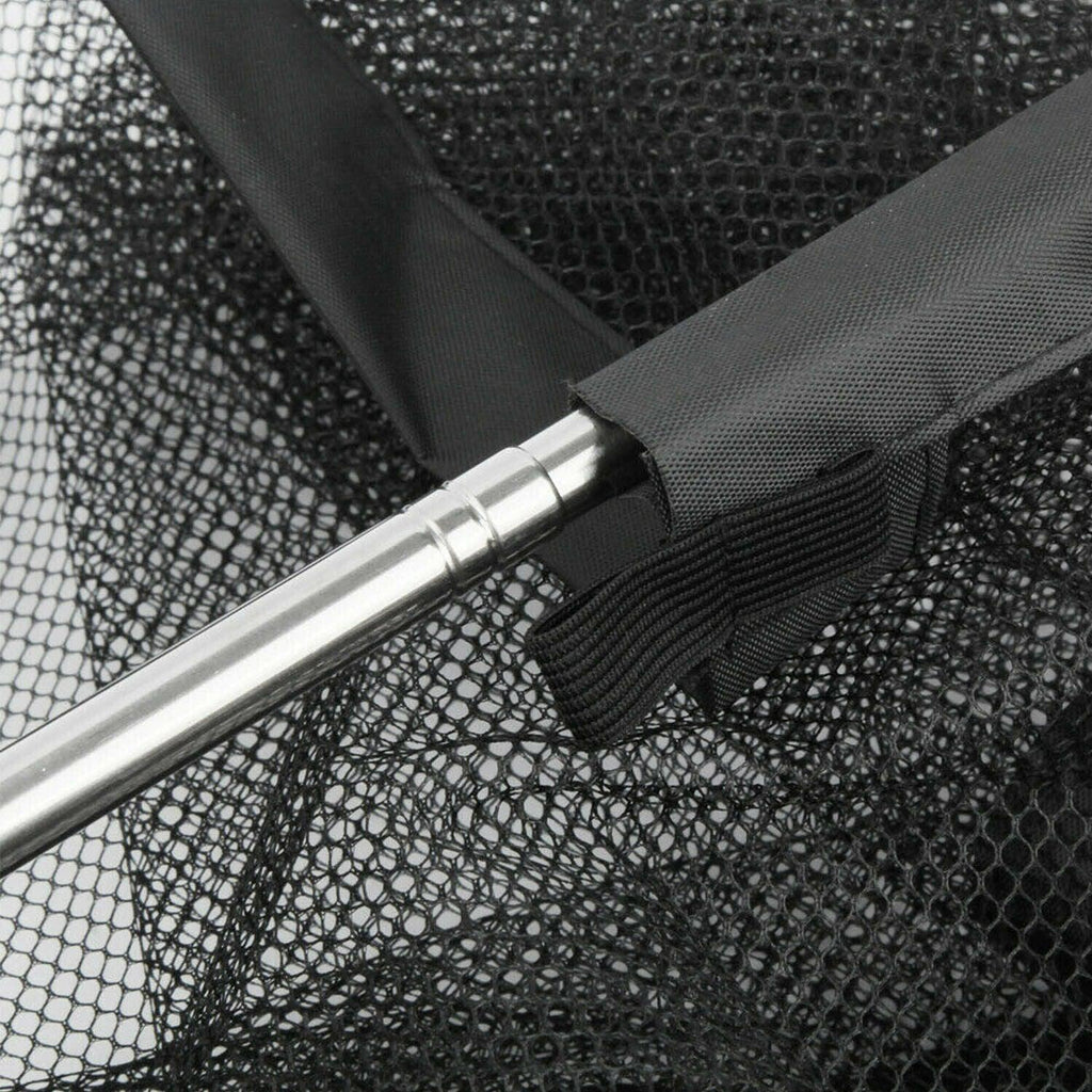 Black portable mesh pet safety gate with nylon barrier installed in home hallway — view 2