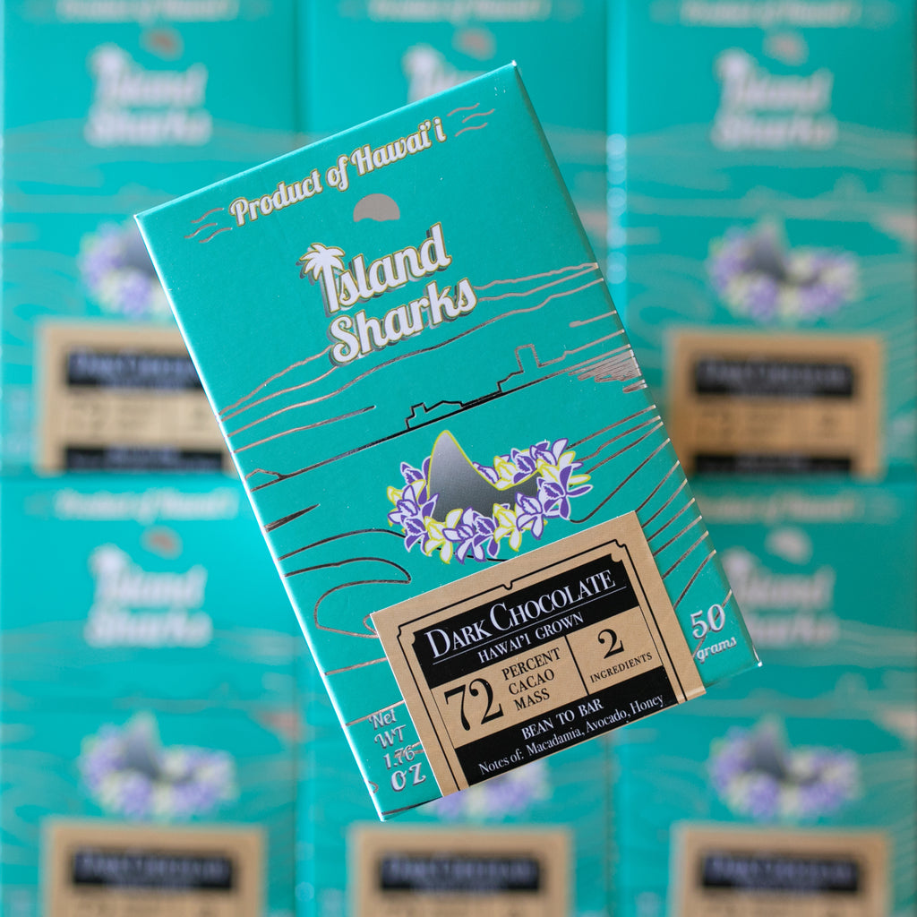 72% Hamakua dark chocolate bars in artisanal eco-friendly wrappers, stacked on a clean surface — view 2