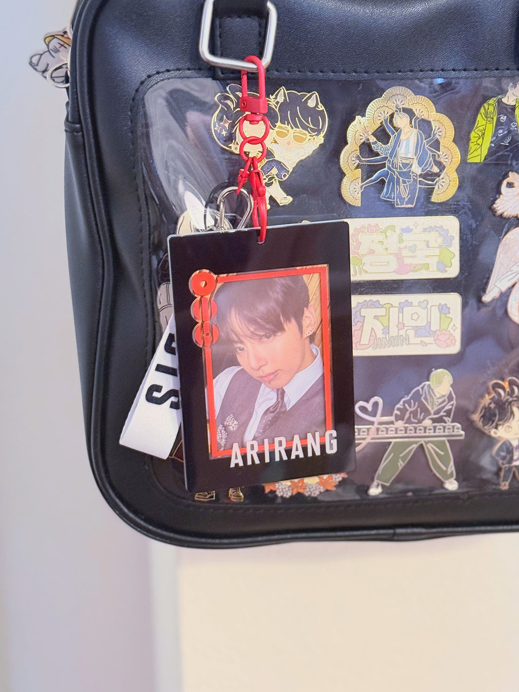BTS Arirang acrylic photocard holder keychain with bold red frame and minimalist display layout. — view 6