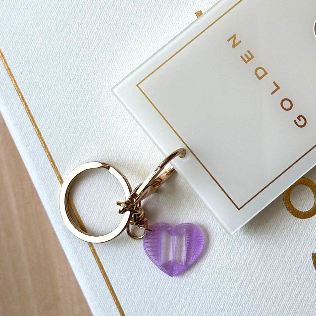 Custom Jung Kook logo charm keychain in vibrant PLA attached to a gold metal keyring — view 5