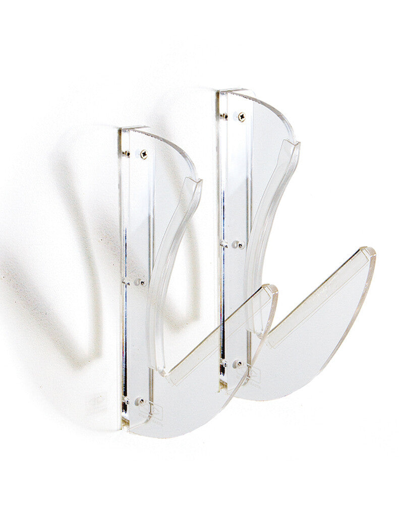 Clear acrylic horizontal surfboard wall display rack with cushioned bumpers supporting a surfboard.