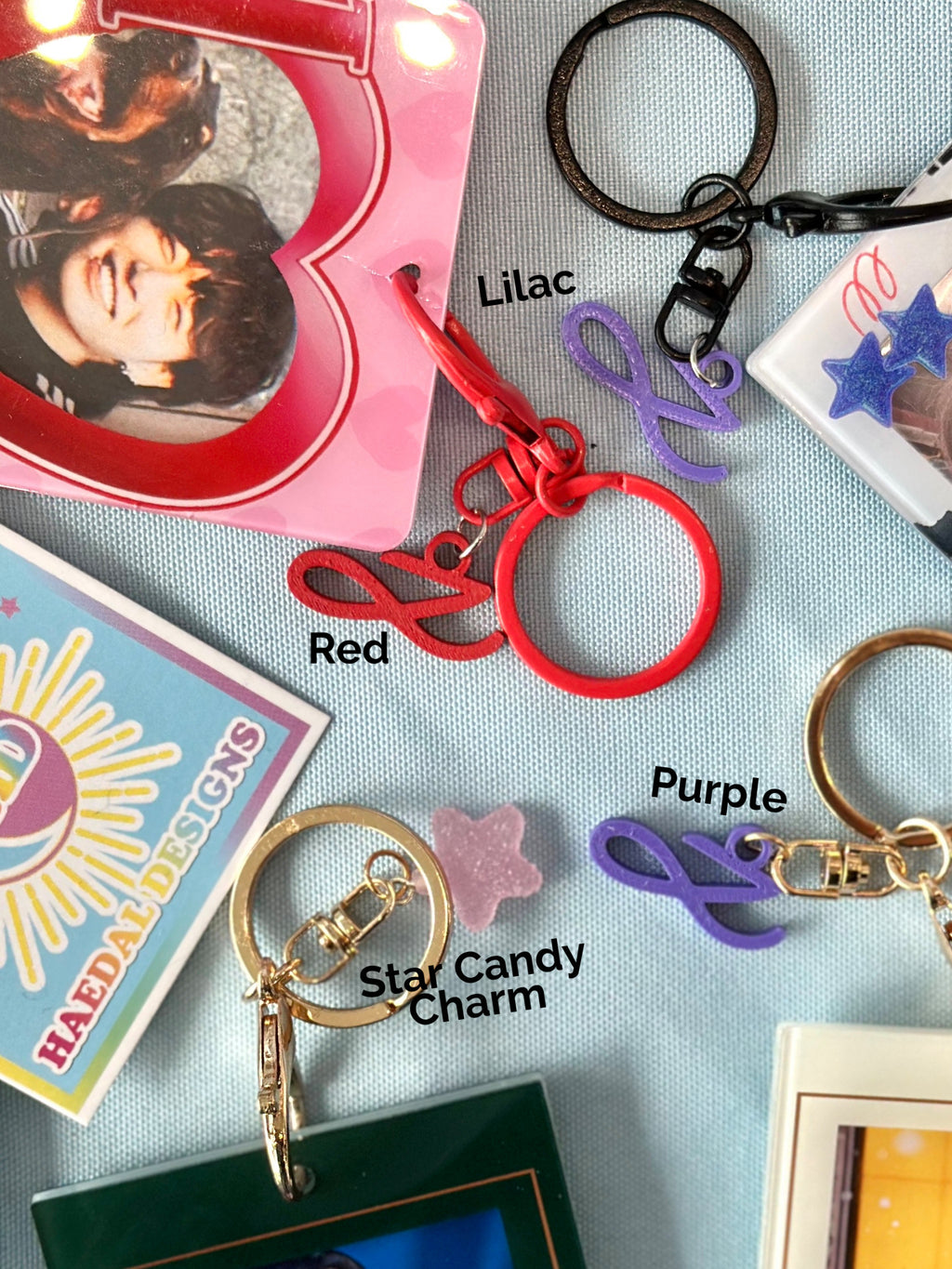 Custom Jung Kook logo charm keychain in vibrant PLA attached to a gold metal keyring — view 2