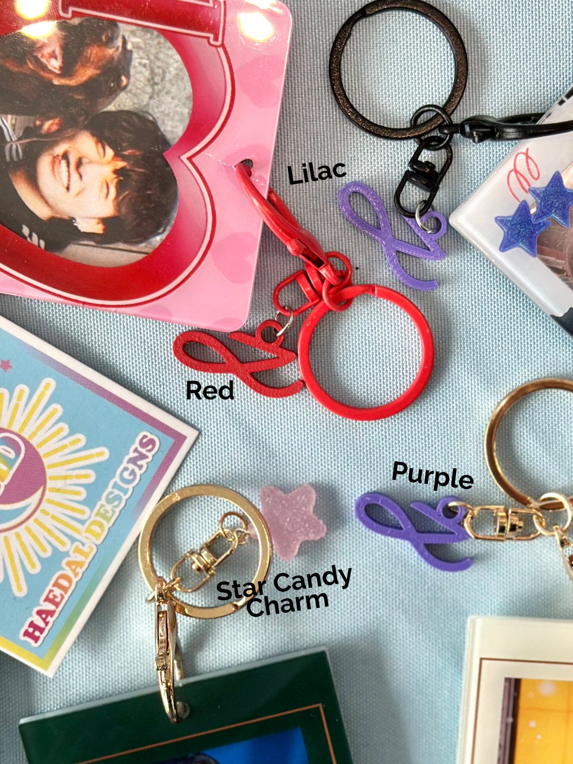 Custom Jung Kook logo charm keychain in vibrant PLA attached to a gold metal keyring — view 2
