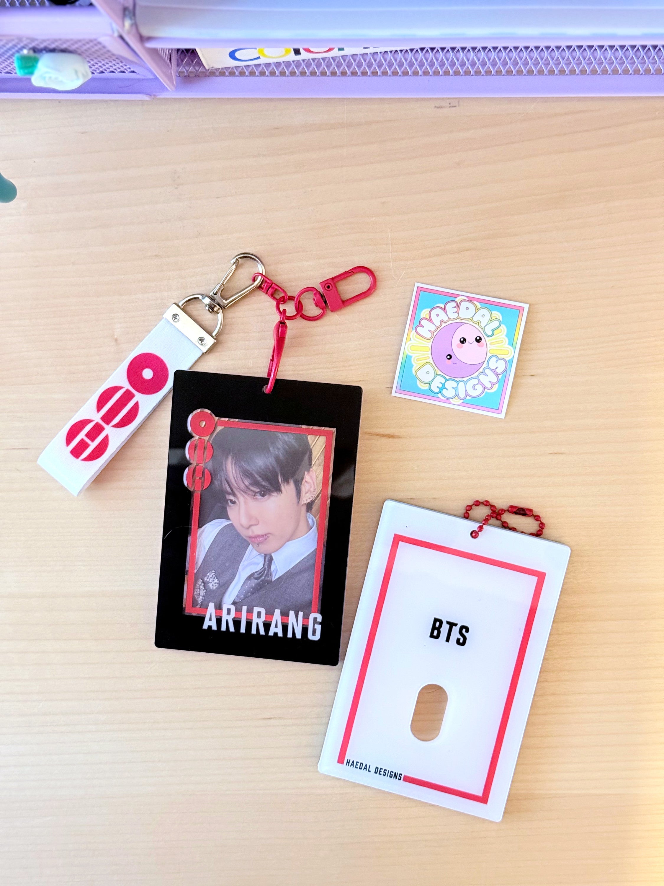 BTS Arirang acrylic photocard holder keychain with bold red frame and minimalist display layout. — view 3