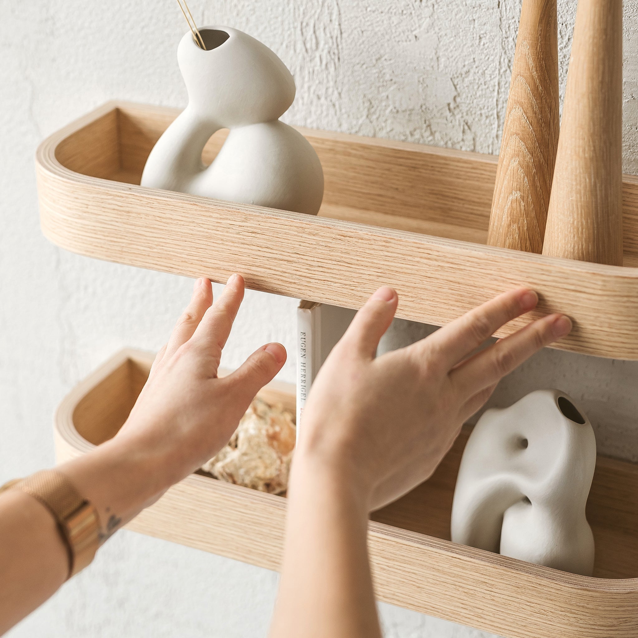 Natural oak wood floating wall shelf holding small decorative plants and picture frames in modern home — view 2