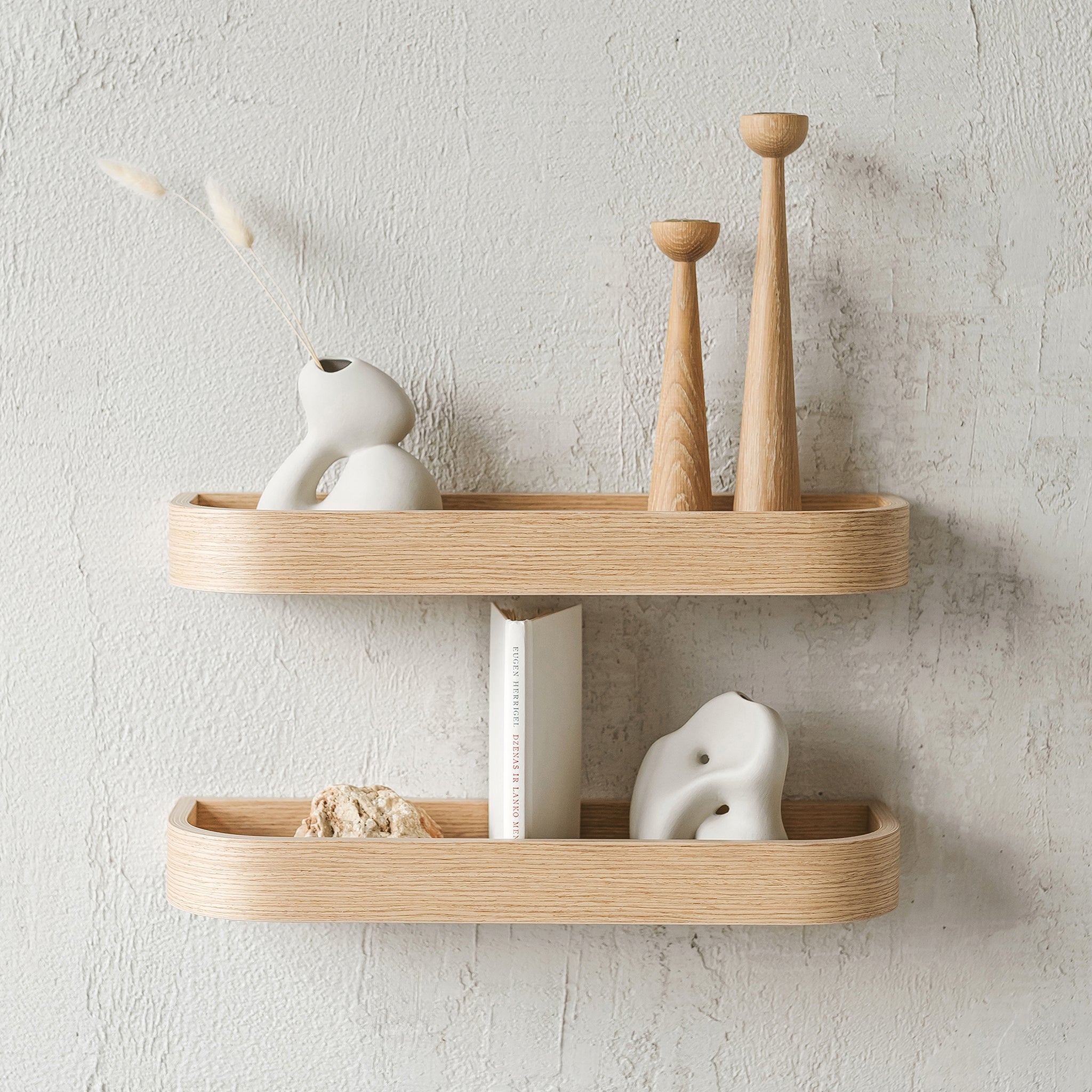 Natural oak wood floating wall shelf holding small decorative plants and picture frames in modern home — view 3