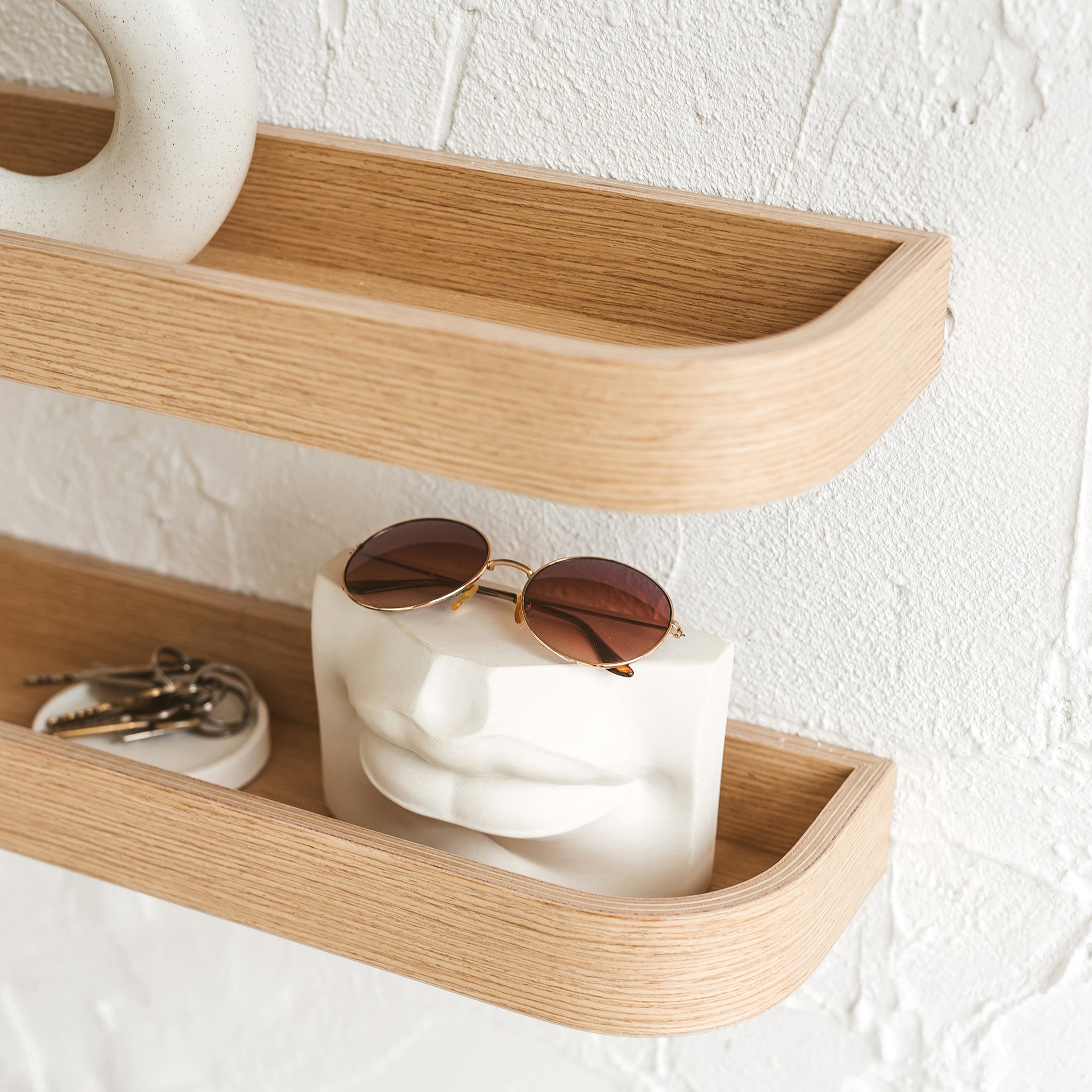 Natural oak wood floating wall shelf holding small decorative plants and picture frames in modern home — view 5