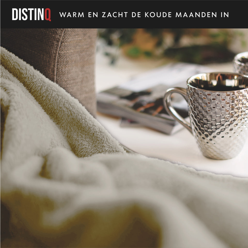 Extra-large beige flannel fleece electric blanket spread neatly over a comfortable couch — view 8