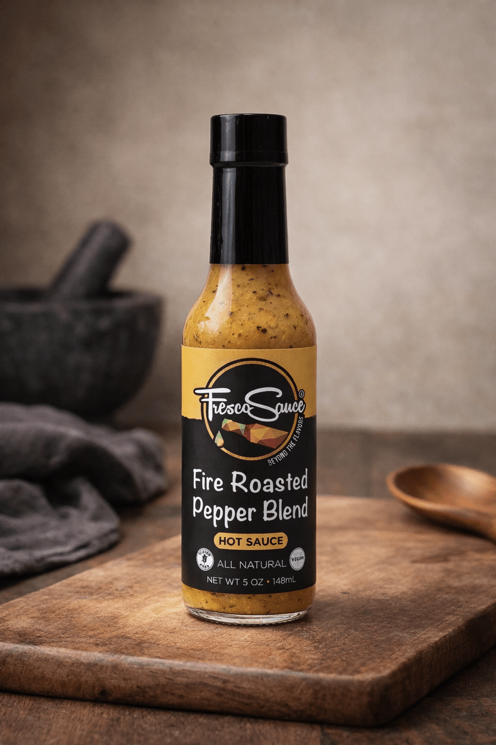 Fire Roasted Pepper Blend Hot Sauce in a glass bottle with fresh jalapenos — view 3