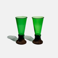 Green shot glasses made from upcycled glass bottles arranged neatly for a party setting