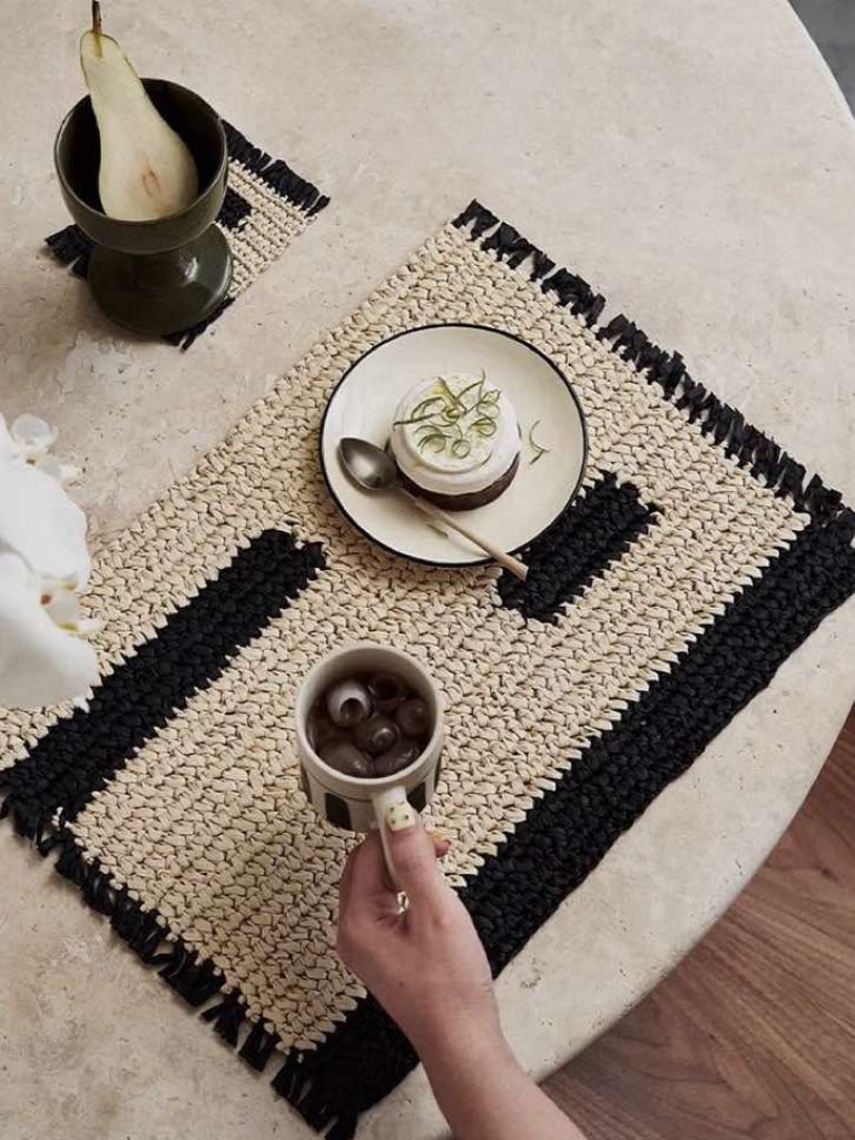Retro handwoven natural reed placemat set of four on an elegantly styled Nordic dining table