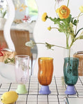 Handmade wavy beer glass in clear borosilicate glass filled with a golden craft beverage