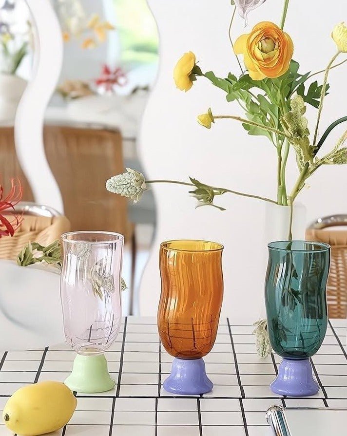 Handmade wavy beer glass in clear borosilicate glass filled with a golden craft beverage