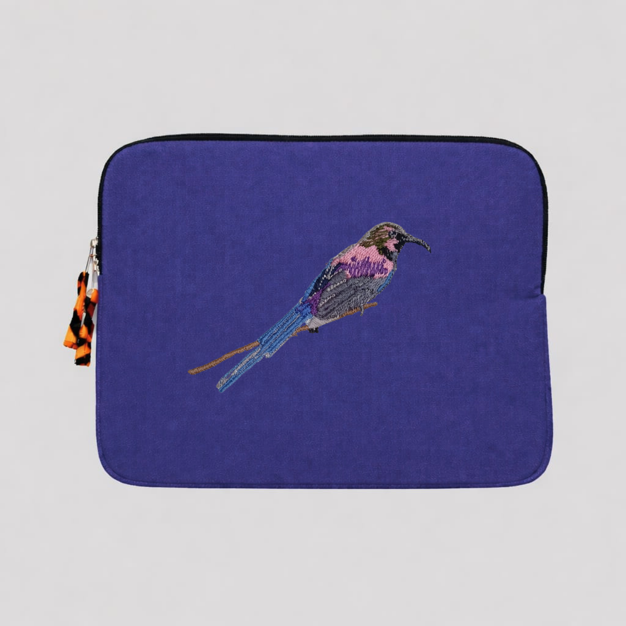 Tacazze Sunbird cotton canvas laptop sleeve featuring detailed bird embroidery in warm earthy colors