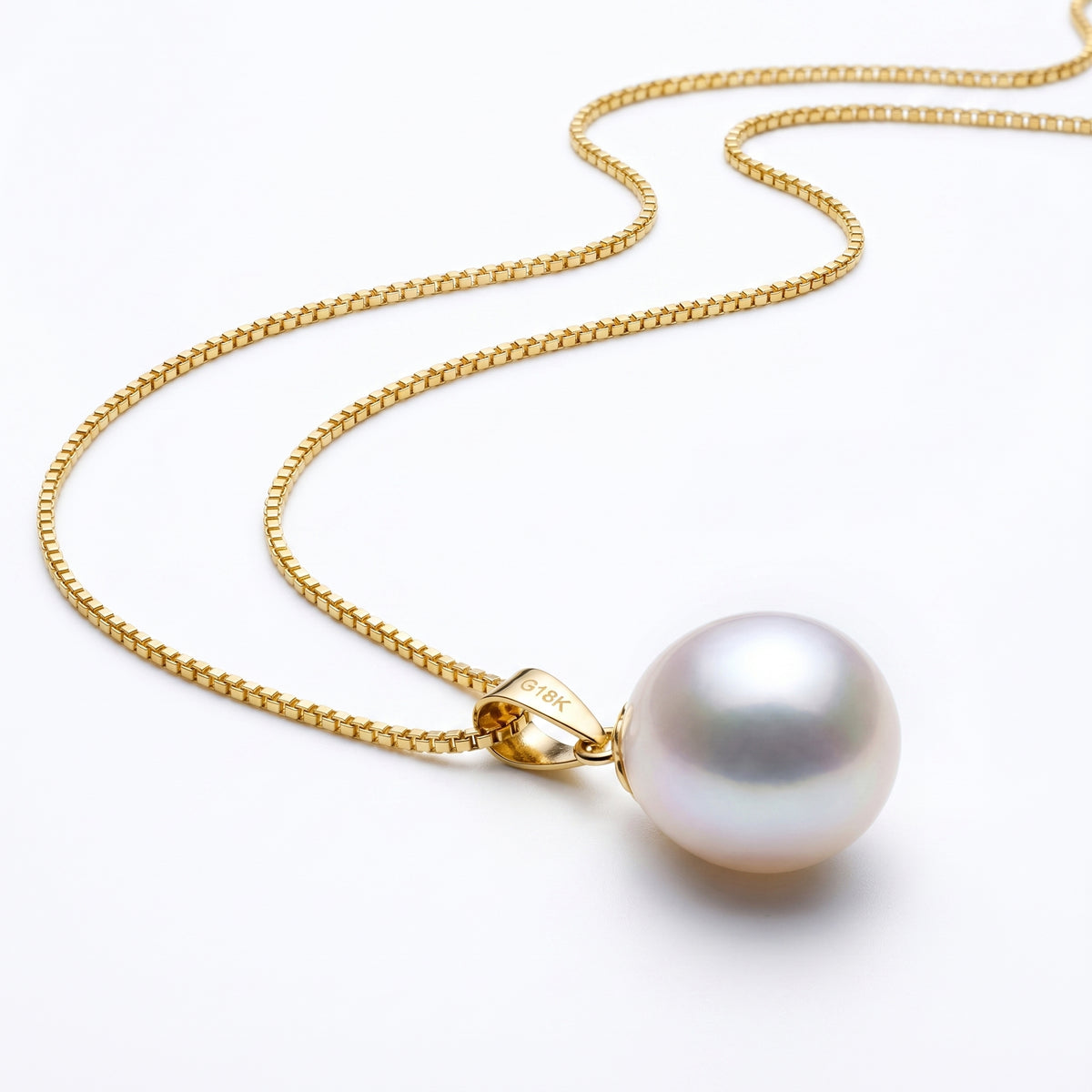 Close-up of fine 18K gold plated box chain with freshwater pearl pendant.