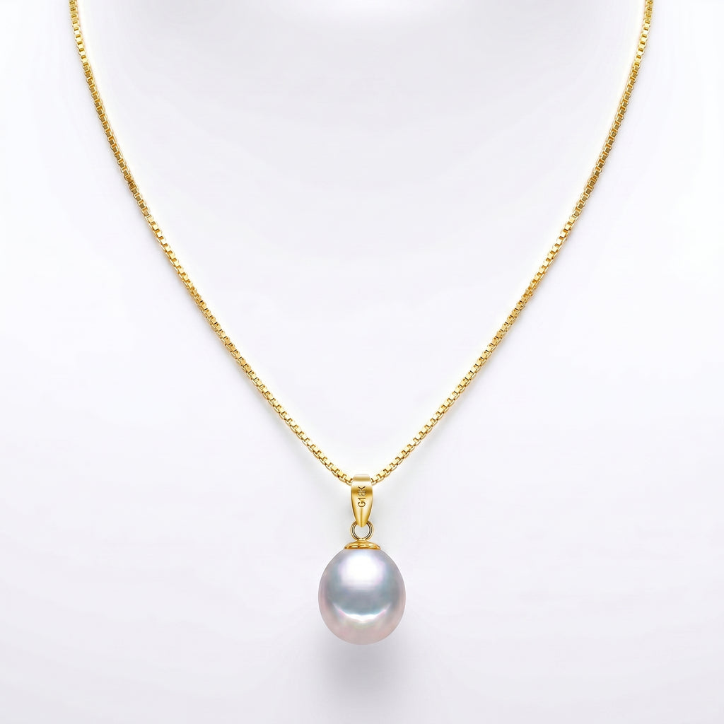 Freshwater pearl pendant necklace displayed on luxury stone pedestal with soft natural light.