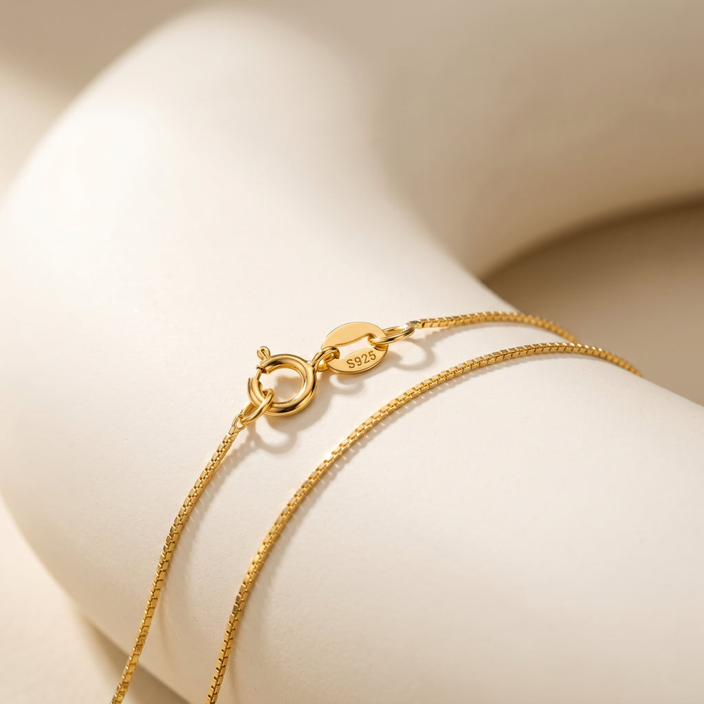  displayed on a handcrafted ceramic tray with elegant box chain detail.
