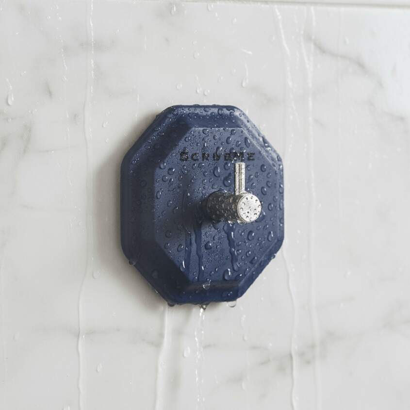 Self adhesive wall hook on a smooth bathroom tile holding a blue hanging shower towel — view 4