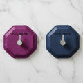 Self adhesive wall hook on a smooth bathroom tile holding a blue hanging shower towel