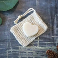 Round zero waste hydrating solid conditioner bar infused with lavender and shea butter on soap dish