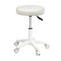Beige PU leather rolling salon stool with 360 degree swivel wheels and adjustable steel frame