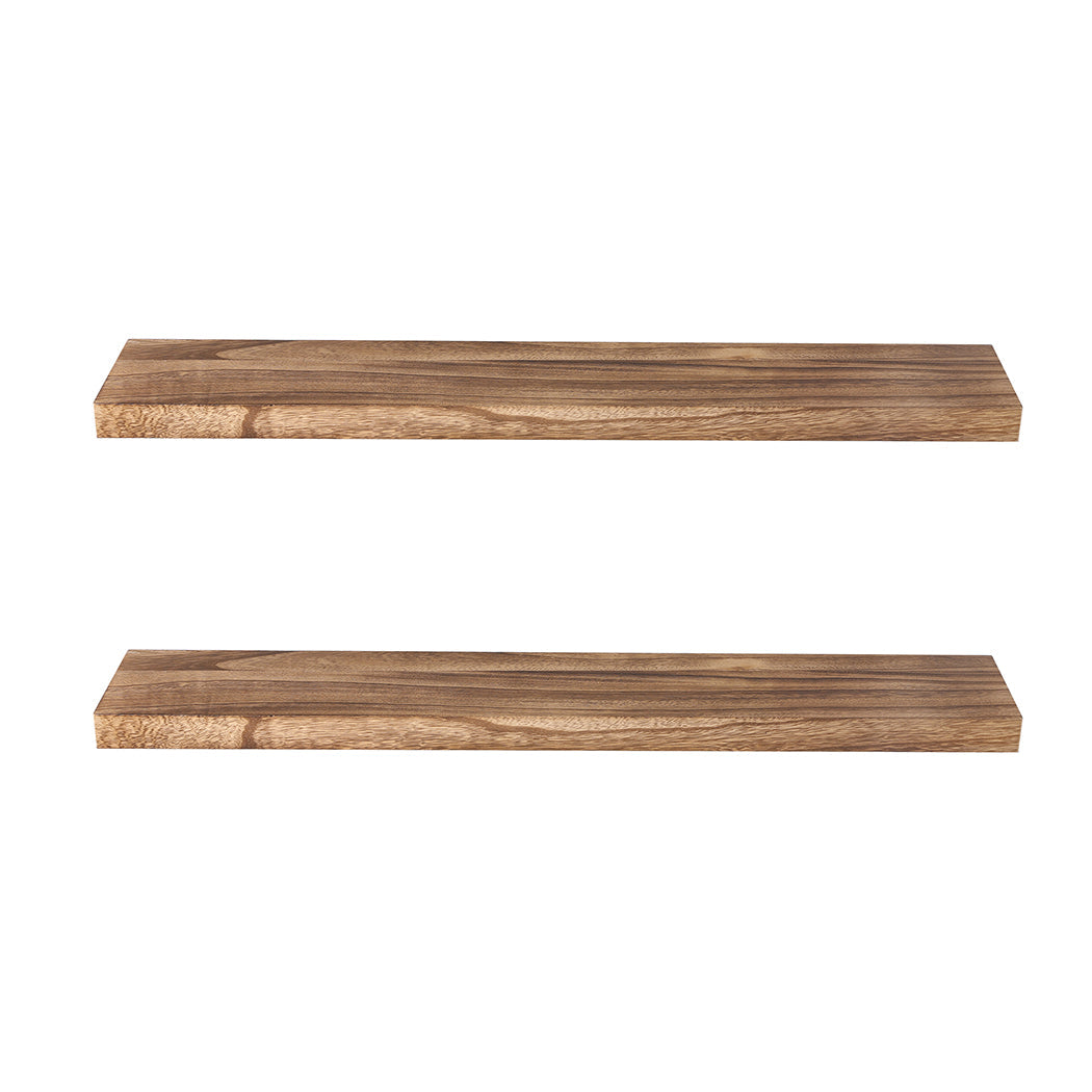 Two natural Paulownia wood floating shelves mounted on a wall displaying decorative living room items