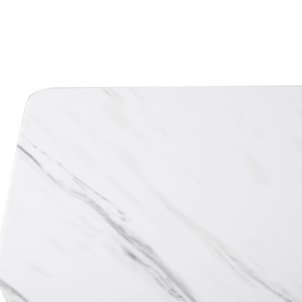 Marbled white adjustable standing desk with steel frame and hidden wheels next to a modern sofa — view 5