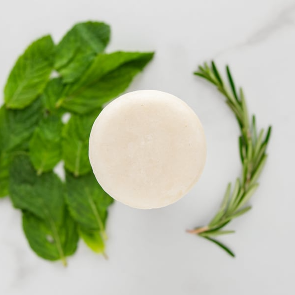 Sulfate-free shampoo bar showing natural botanical texture and eco-friendly plastic-free packaging. — view 2