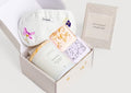 Green lemon spa gift box with glass scented candle, two shower steamers, and sleeping eye mask